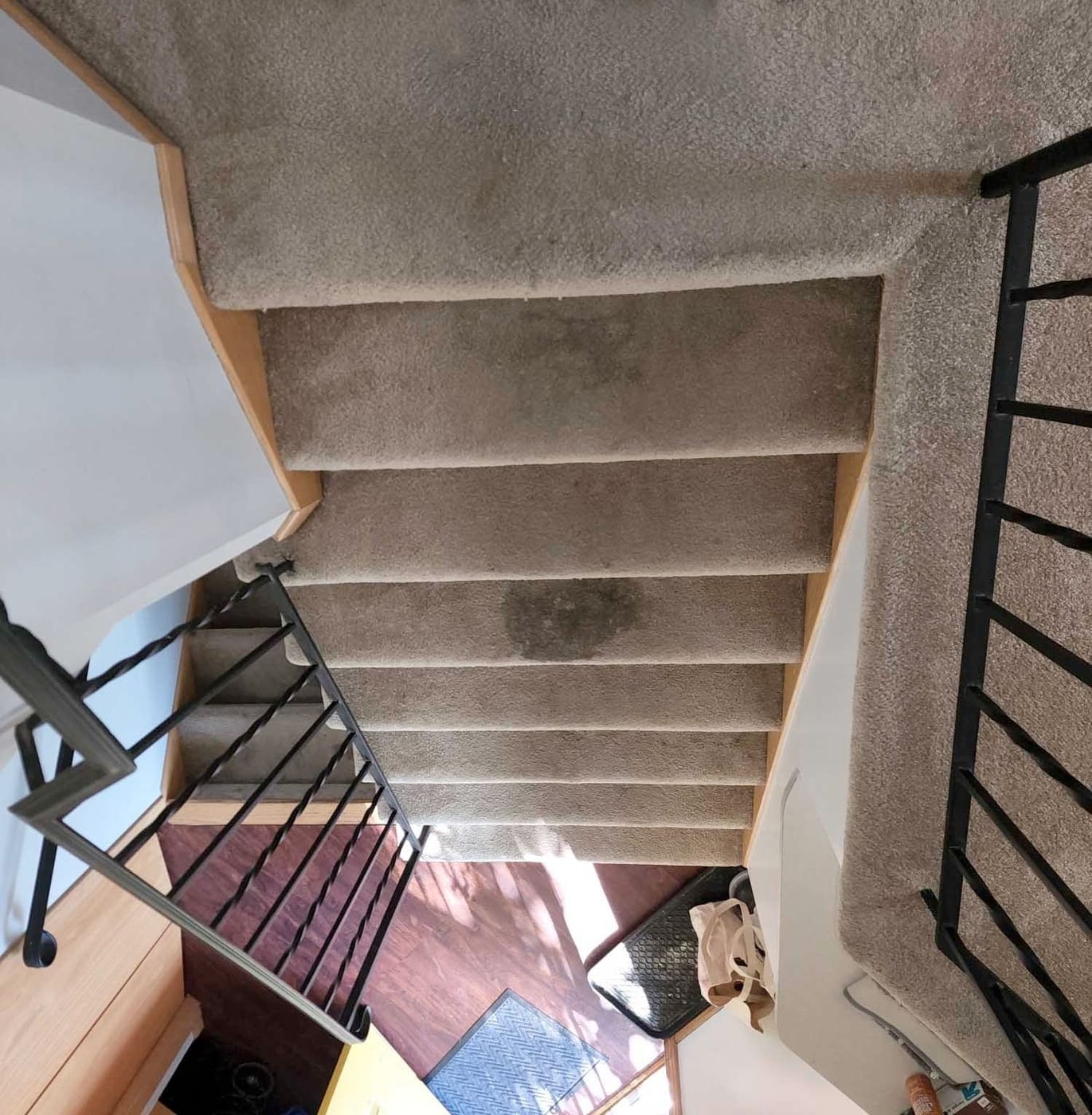 Carpeted stairs before cleaning, with marks down the middle of the treads