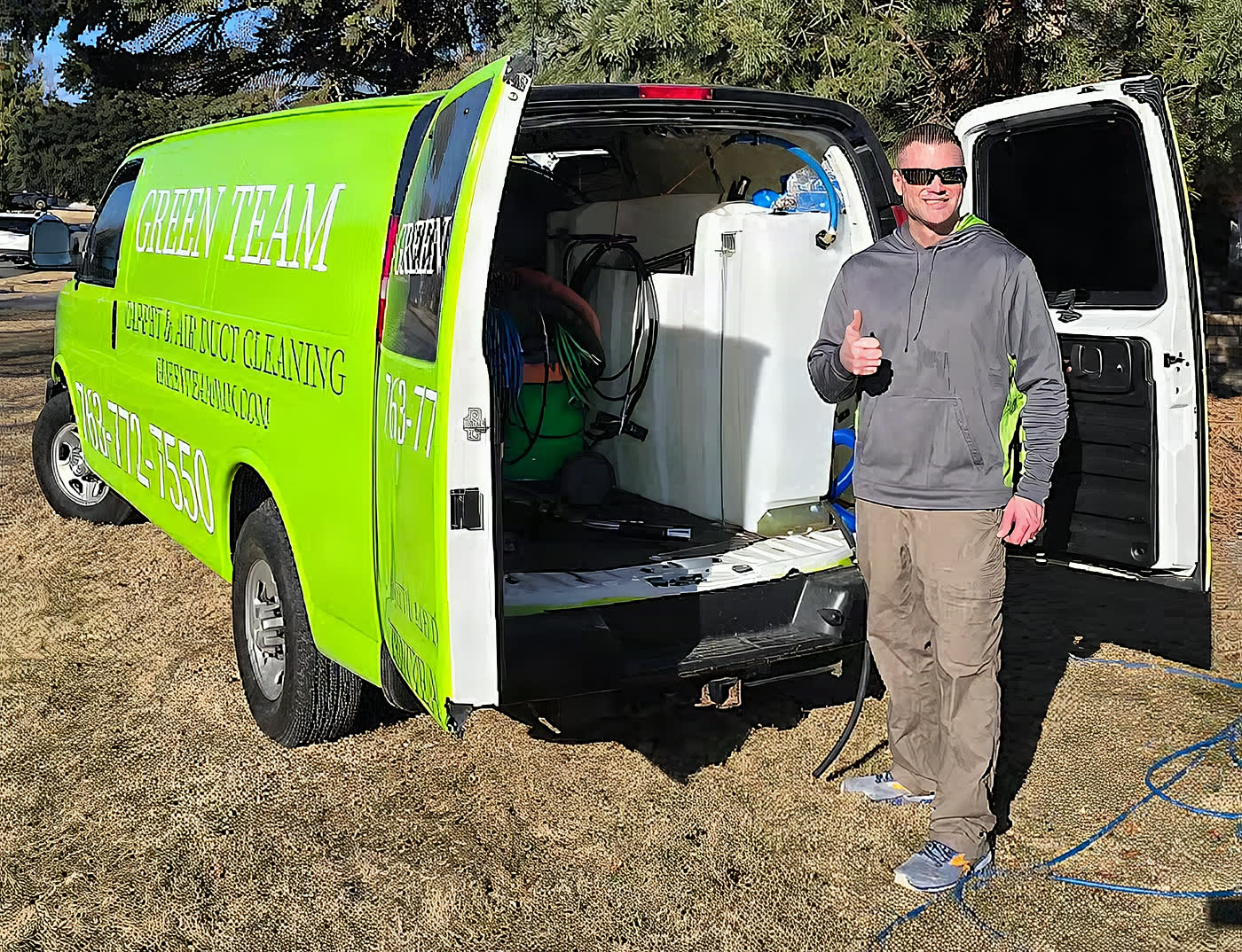A Green Team crew member at the open doors of the green van